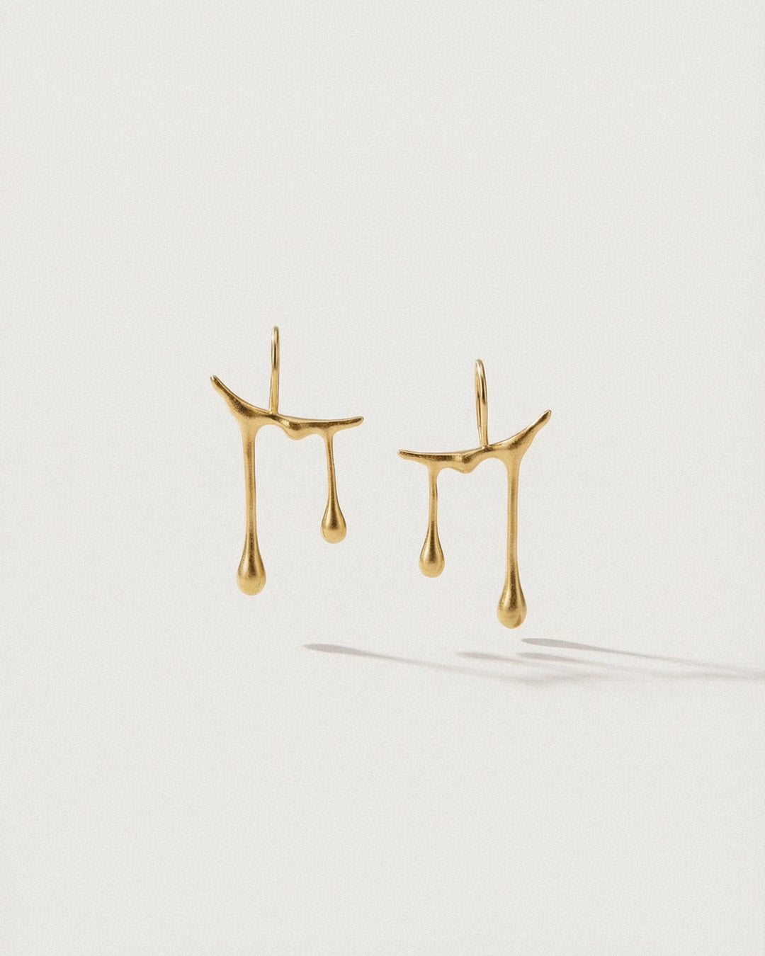Chopin Raindrop Gold earrings on a white background