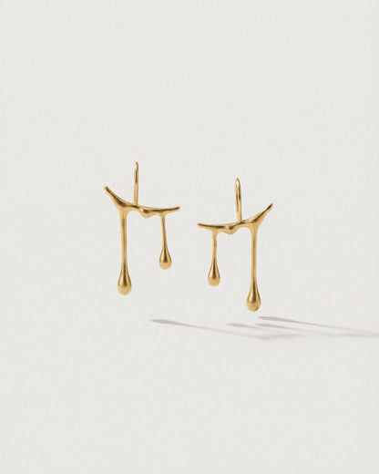 Chopin Raindrop Gold earrings on a white background