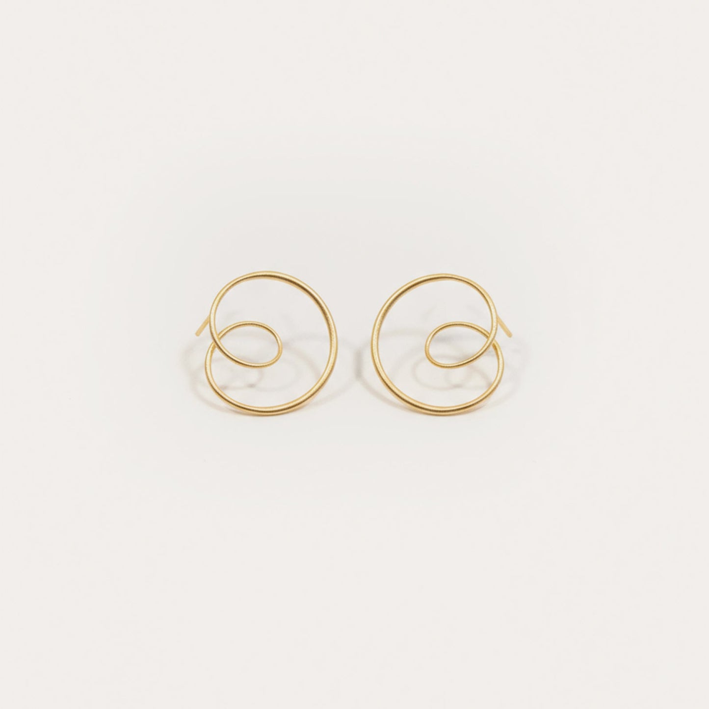 Gold hoop earrings on a white background