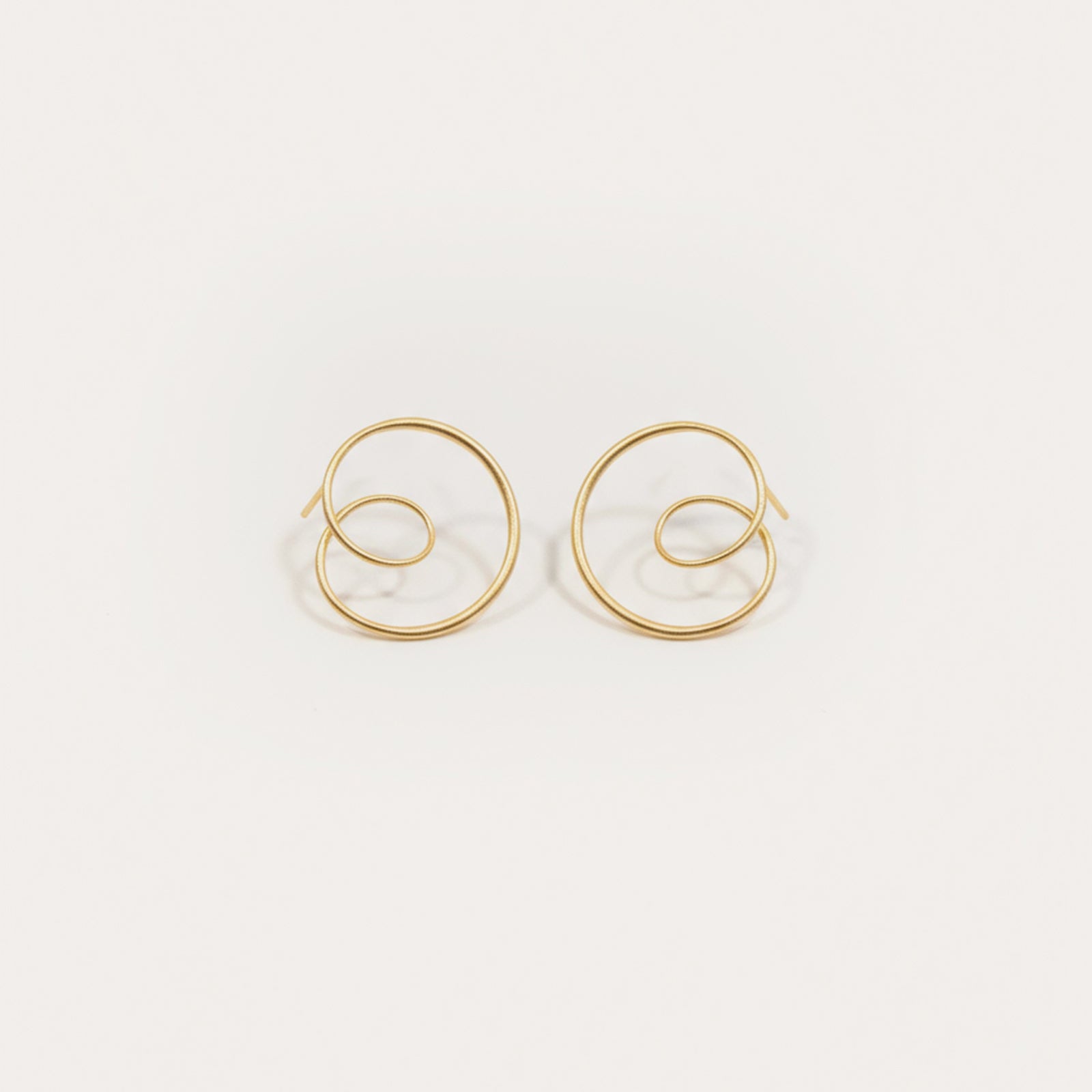 Gold hoop earrings on a white background