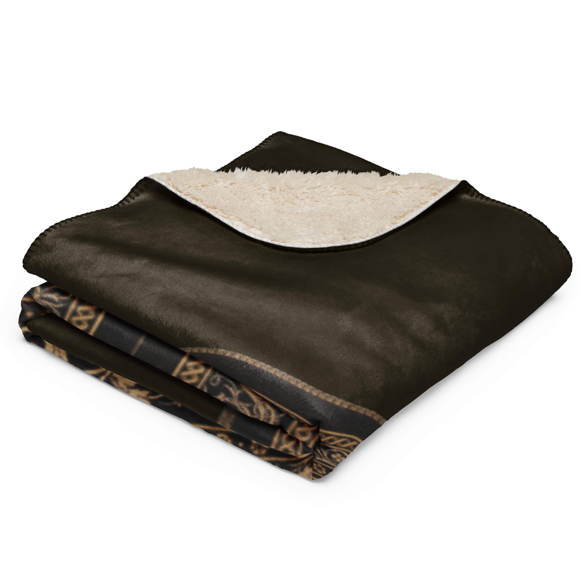 Folded black and beige blanket with intricate patterns on a white background